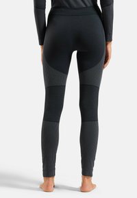 Schwarze Leggings mit strukturierten Einsätzen in verschiedenen Grautönen. Enganliegendes Design mit hohem Bund und geripptem Stoff an den Knöcheln.