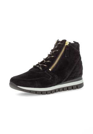 Zwarte suede hoge sneakers met vetersluiting aan de voorkant, zijrits, gouden hardware, getextureerde details en een witte rubberen zool.