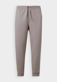 Pantaloni de trening gri deschis, confecționați dintr-un material moale, dotati cu un brâu elastic cu șnur, manșete îngustate și buzunare laterale.
