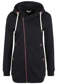 Felpa nera con zip, dotata di un ampio cappuccio, cordini crema a contrasto e accenti triangolari marroni sulle tasche. Texture morbida, design casual.