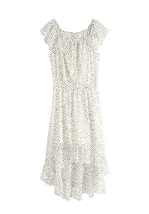 Hvid ærmeløs kjole med små sorte polkaprikker, flæset off-shoulder halsudskæring, elastisk talje og asymmetrisk skørt.