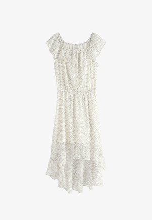 Hvid ærmeløs kjole med små sorte polkaprikker, flæset off-shoulder halsudskæring, elastisk talje og asymmetrisk skørt.