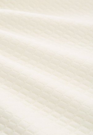 Világos krémszínű szövet, melyet texturált, gyémántmintás dizájn jellemez. Puha, sima tapintás és enyhén fényes felület.