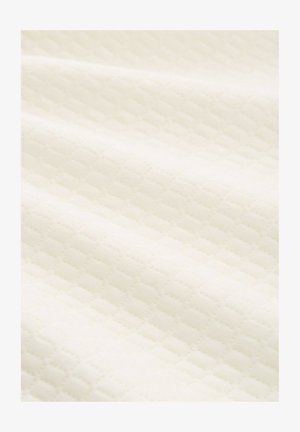 Világos krémszínű szövet, melyet texturált, gyémántmintás dizájn jellemez. Puha, sima tapintás és enyhén fényes felület.