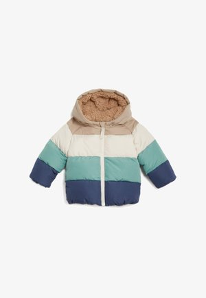 Kurtka pikowana z kapturem, z beżowymi, morsko-zielonymi i granatowymi poziomymi paskami oraz miękką, brązową podszewką z polaru. Zapięcie na zamek błyskawiczny z przodu.