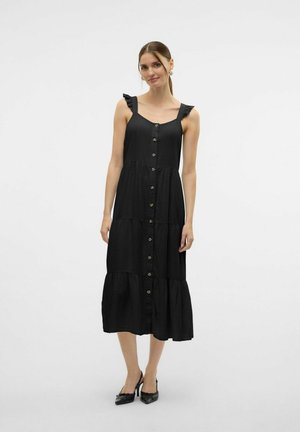 Vestido maxi negro con tirantes con volantes, frente con botones, falda en capas y textura de tela suave. Presenta un dobladillo acampanado.