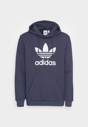 Marineblaue Adidas Kapuzenjacke mit weißem Trefoil-Logo und Schriftzug vorne, mit Fronttasche und verstellbarer Kordelzug-Kapuze.