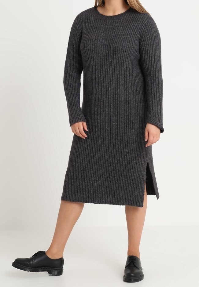 Long, ribbed grey knit dress with a crew neckline and side slits. Worn with black lace-up shoes. Textured fabric visible.