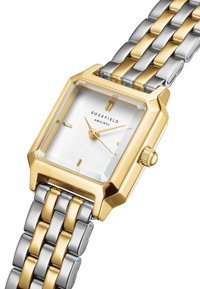 Montre carrée avec boîtier en or jaune et bracelet en acier inoxydable argenté. Le cadran blanc présente des index et des aiguilles dorés. Comprend une couronne sur le côté.
