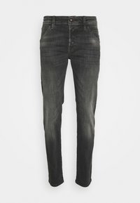 Svarta denimjeans med slim fit. Har subtila blekta områden, fem fickor och knappstängning. Sömmar med fint broderi.