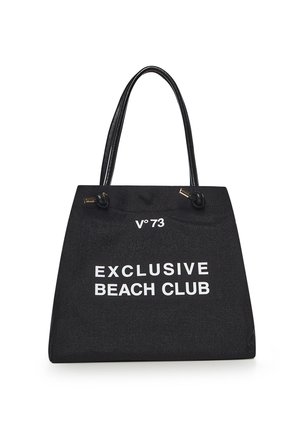 Black tote bag with double handles, text "V°73 EXCLUSIVE BEACH CLUB" in white on front, textured fabric, gold hardware accents.