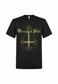 Svart bomulls-t-shirt med en guldfärgad grafisk design med texten "Mercyful Fate" och cirkulära mönster, placerad mitt på framsidan.