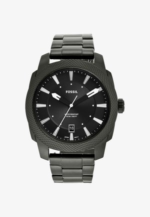 Zwart Fossil polshorloge met ronde gestructureerde bezel, zilverkleurige uurmarkeringen, datumaanduiding op 6, en metalen schakelband die 9:10:36 aangeeft.