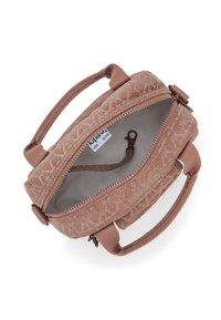 Sac à main en velours côtelé rose avec des poignées en tissu, fermeture éclair et clip intérieur. L'intérieur est doté d'une doublure unie de couleur claire.
