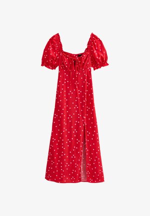 Robe rouge à pois avec des manches ballons courtes, un détail à nouer au niveau du décolleté et une fente à l'avant. Fabriquée en tissu léger avec une texture lisse.