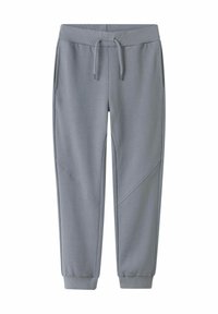 Grå sweatpants av mjukt material, med en ribbad midja, fickor, avsmalnande ärmslut och diagonala designaccenter.
