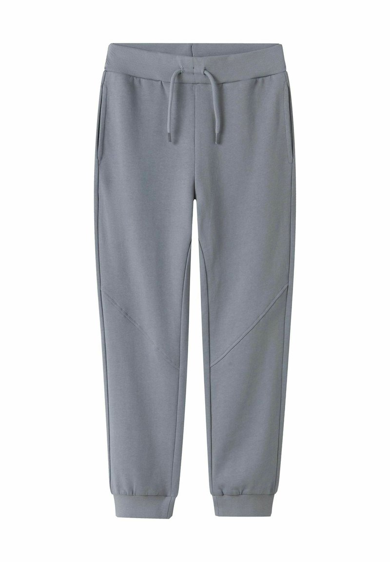 Grå sweatpants av mjukt material, med en ribbad midja, fickor, avsmalnande ärmslut och diagonala designaccenter.