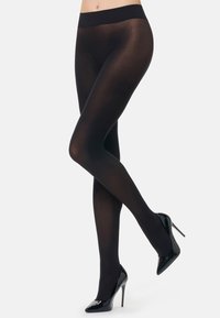 Collant neri opachi con una vasta fascia elastica in vita, texture liscia e finitura uniforme, abbinati a tacchi alti neri.