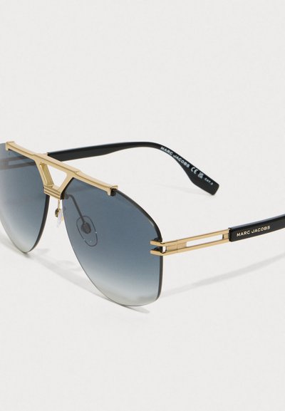 Sunglasses with gold frame and gradient blue lenses, black arms featuring Marc Jacobs branding on the temple.