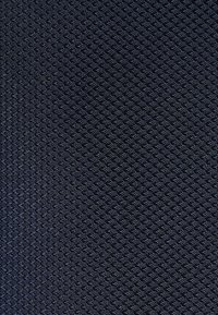 Navy blue textured fabric featuring a diamond pattern with raised circular accents, conveying a structured and durable appearance.