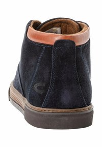 Navy blue suede ankle boot featuring a tan leather collar, rubber sole, and stitched detailing along the edges for durability.