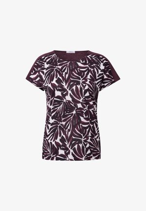 Lyhythihainen paita valkoisena, jossa tummanmarjapuuron värinen kasvikuviopainatus. Hihansuissa ja kaula-aukossa on tummanmarjapuuron värinen kiilto pehmeästä kankaasta.