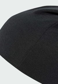 Black knitted beanie with fine, textured weave. Rounded shape with a subtle seam detail. Smooth finish and flexible stretch fabric.
