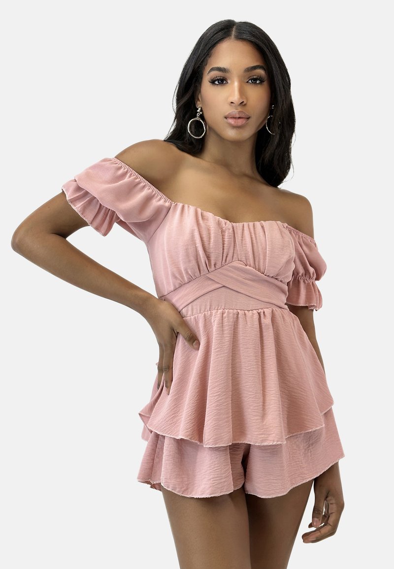 Rosa schulterfreier Overall mit Rüschensäumen, gestuftem Rock und bequemen Shorts. Aus leichtem, strukturiertem Stoff gefertigt.