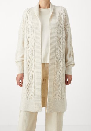 Cardigan lungo a maglia cable in crema, con polsini a costine e design aperto. Texture morbida con vestibilità leggermente oversize.