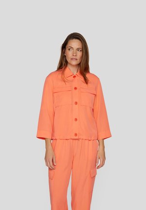 Coral-orange, cropped jacket with a button-down front, two chest pockets, and wide sleeves, complemented by matching pants. Smooth texture.