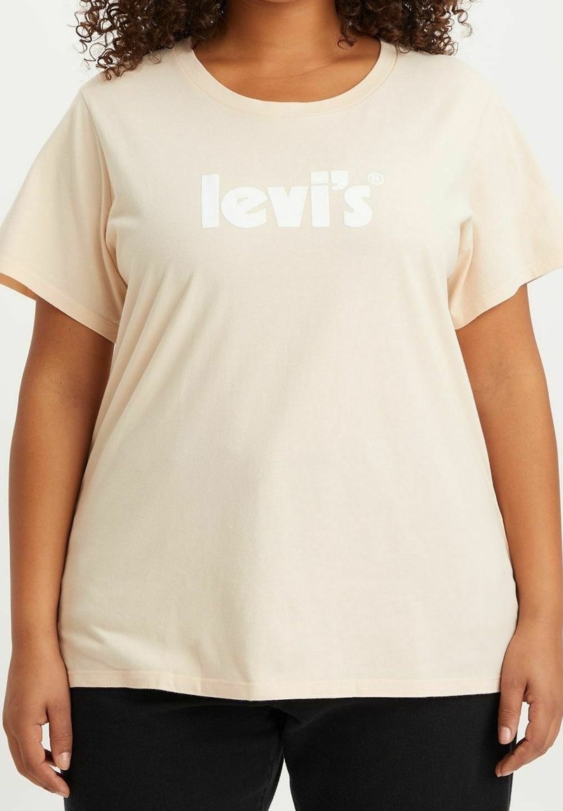 Světle růžové tričko s krátkým rukávem z bavlny. Na přední straně se nachází bílé logo "levi's". Klasický design s kulatým výstřihem.
