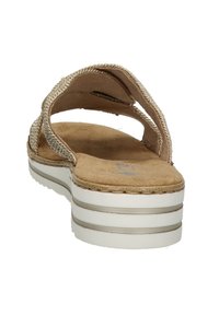 Beige platform sandal with woven upper, soft suede insole, white midsole, and silver accent stripes. Open-back design for easy wear.