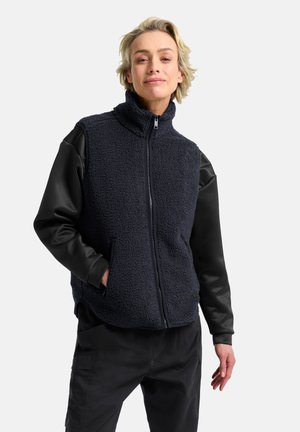 Gilet en polaire marine avec col montant, fermeture éclair et manches en cuir noir. Dispose de deux poches latérales et d'un matériau texturé. Design décontracté.