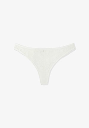 White lace thong featuring intricate floral patterns, thin elastic bands, and scalloped edges. Soft texture with a delicate finish.