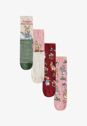 Set aus vier Socken mit verschiedenen Designs: "Hoppy Holidays"-Text, Hasenillustrationen, Streifen, Punkte und Feiertagsmuster in Grün, Pink, Rot und Beige.