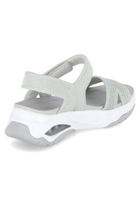 Sandale gris clair avec une tige en maille extensible, des sangles ajustables et une semelle plateforme avec un intercalaire blanc et des accents gris.