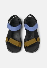 Black sandals with blue and brown adjustable straps. Textured black sole with a patterned design. Hook-and-loop fastening for secure fit.