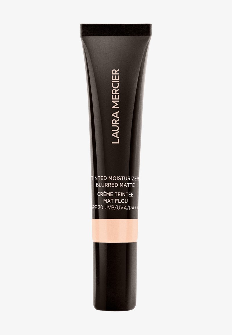 Svart tube med matt finish, beige sokkel og hvit tekst. Har "Laura Mercier" logo og produktdetaljer. SPF 30 angitt.