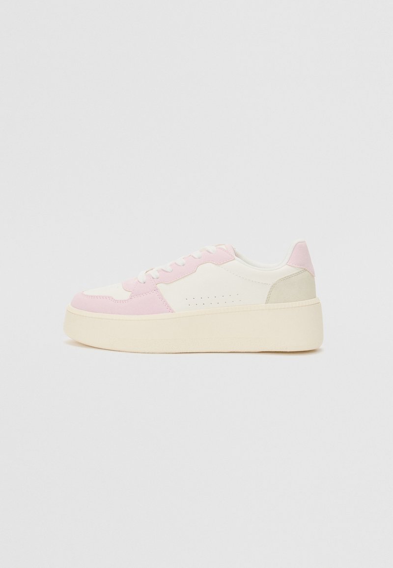 Low-top sneakers featuring a white and pink upper with suede accents, a textured beige sole, and perforated detailing on the side.