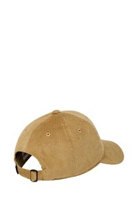 Tan corduroy cap with a rounded crown, flat visor, and adjustable strap. Features a textured surface and stitched detailing.