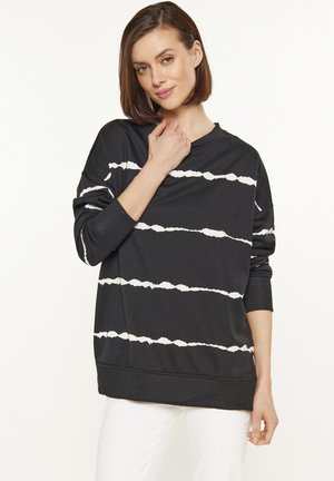 Felpa nera con motivo a strisce ondulate bianche, vestibilità oversize, maniche lunghe, scollatura tonda e polsini rigati. Tessuto morbido.