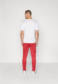 Puma GALATASARAY ISTANBUL TRAINING PANTS - Fanartikel - red rhythm/intense orange