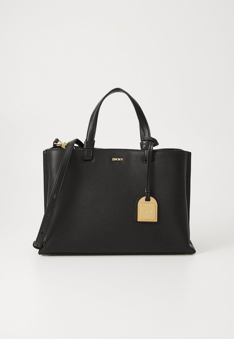 Black leather handbag with structured design, top handles, adjustable shoulder strap, and gold hardware accents including a name tag.