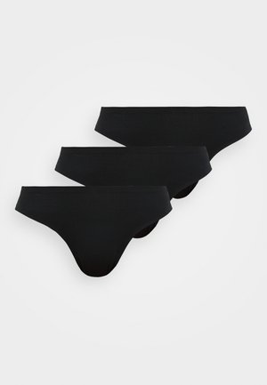 Tre sorte sømløse dameunderbukser med bikini-cut lagt fladt ud, overlappende, på en hvid baggrund.