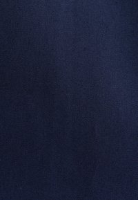 Dark blue fabric texture with tightly woven fibers creating a uniform pattern across the surface.