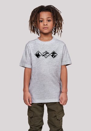 Gray cotton t-shirt with short sleeves featuring three black geometric patterns on the front. Worn with cargo pants.