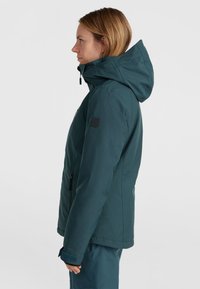 Teal thermal jacket with a hood, textured fabric, side zipper pockets, and adjustable cuffs. Clean lines and fitted design.