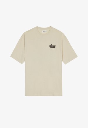 Camiseta de algodón beige con mangas cortas, cuello redondo y estampado gráfico negro con la palabra "ROME" en la parte delantera.