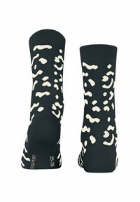 Zwarte sokken met een contrasterend ivoorkleurig abstract luipaardpatroon, gemaakt van zachte stof, met een geribbelde boord, maat gelabeld 35-38.