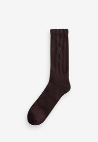 Burgunderfarbene gerippte Socke aus weichem Material mit glatter Textur. Verfügt über ein dezentes Logo an der Außenseite in der Nähe des oberen Randes.